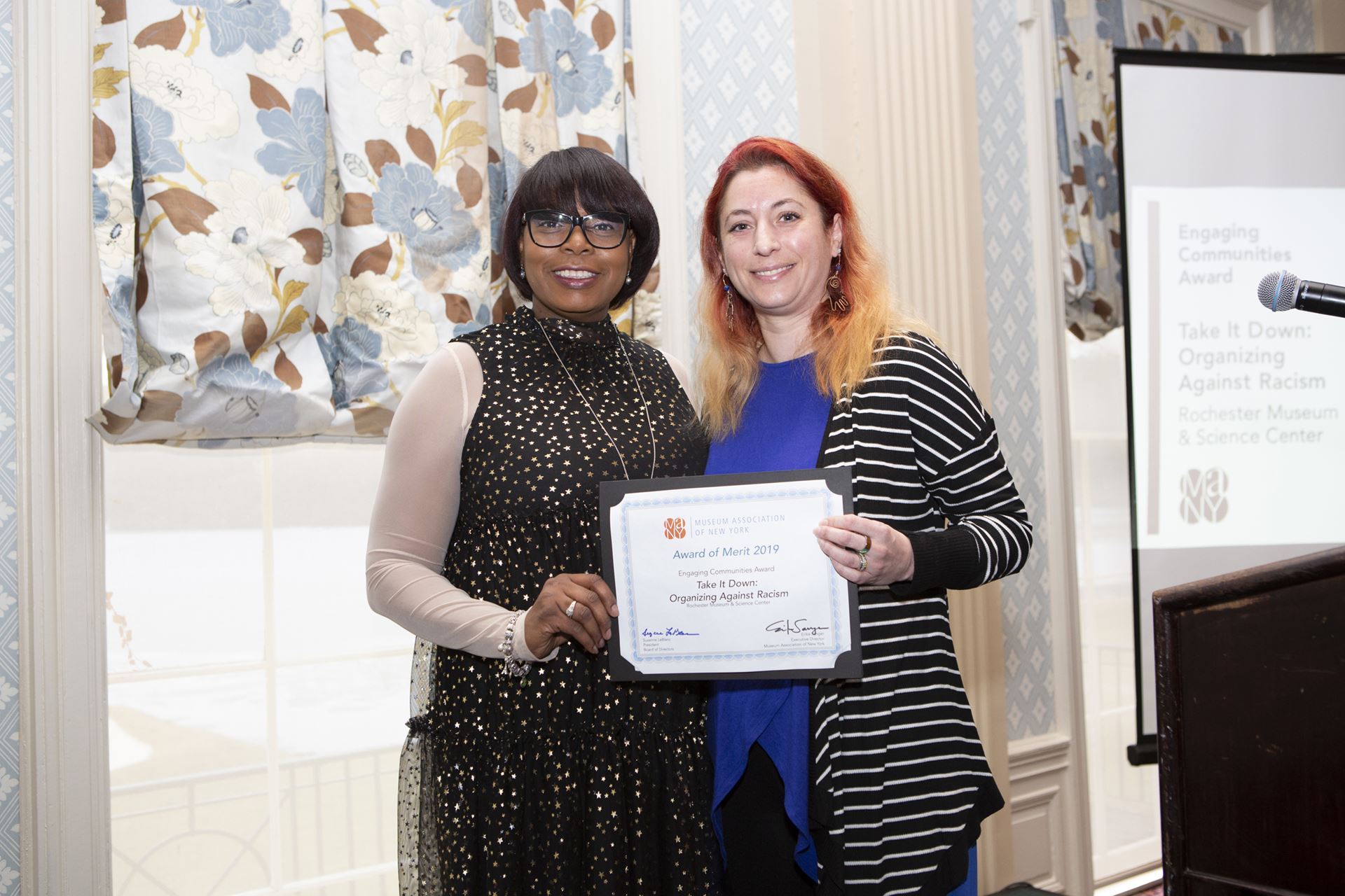 MANY Board Member Georgette Grier-Key with 2019 Engaging Community Award Winner Kathryn Murano-Santos from Rochester Museum of Science for Take it Down. 